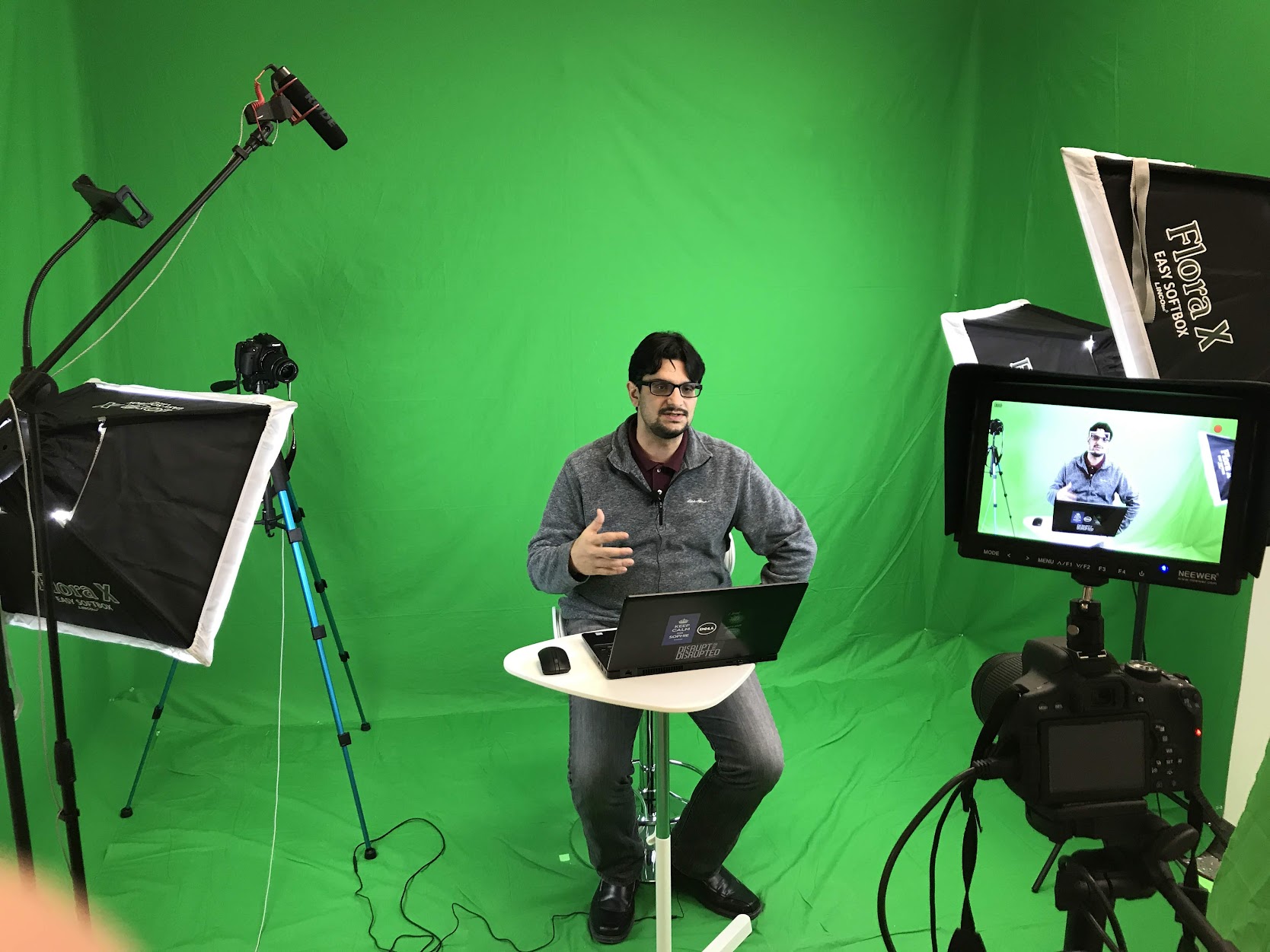 A green screen studio with light and cameras.
