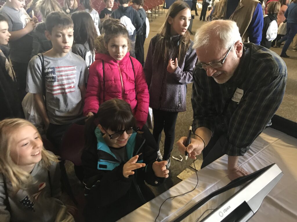 Photo of children playing with 3D zspace display.